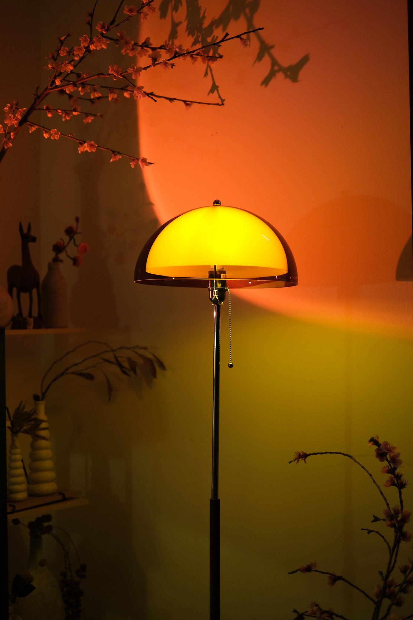 Coby+ Mushroom Bauhaus Floor Lamp Orange with Pull Chain against a warm-toned wall with decorative elements.