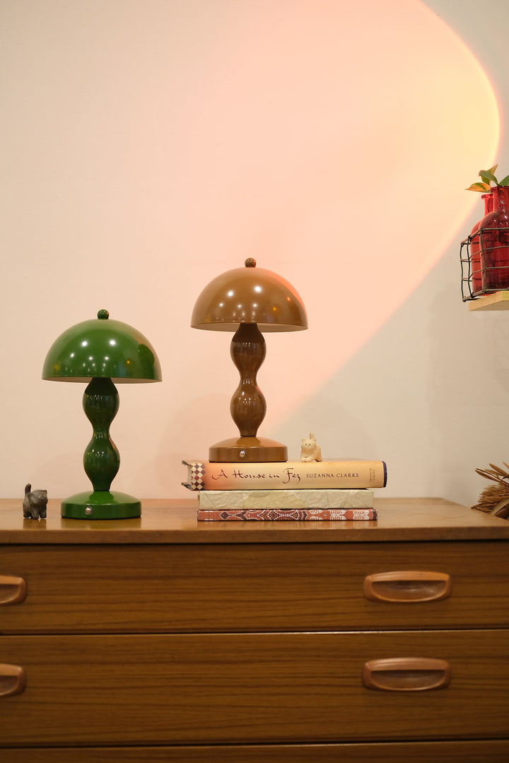 Retro mushroom lamp glowing softly in modern interior décor on a wooden dresser with a neutral background