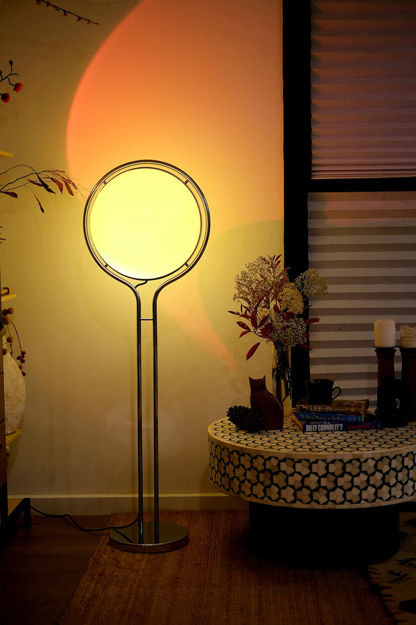 Garreau Globe Floor Lamp Bauhaus Replica Chrome Stand with a round shade in a room setting with a table and decorative items.