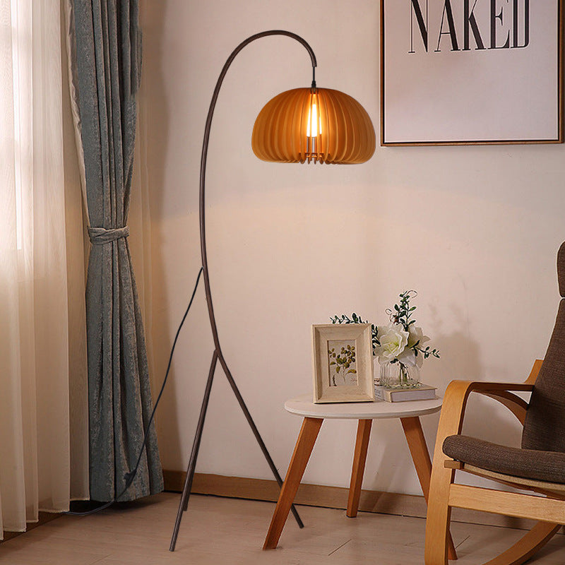 Modern living room with a floor lamp, small table, and chair. Homezee Modern Japandi WABI SABI Tripod Pumpkin shade in a room with a chair and side table.