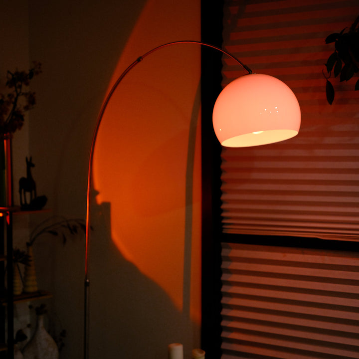  Sneedville+ Bauhaus Arc Floor Lamp with chrome arc and marble base in white shade casting a warm glow in a dimly lit room with posters and decor. Floor lamp with a white shade against a striped wall Pink floor lamp casting a shadow on a wall with a window in the background